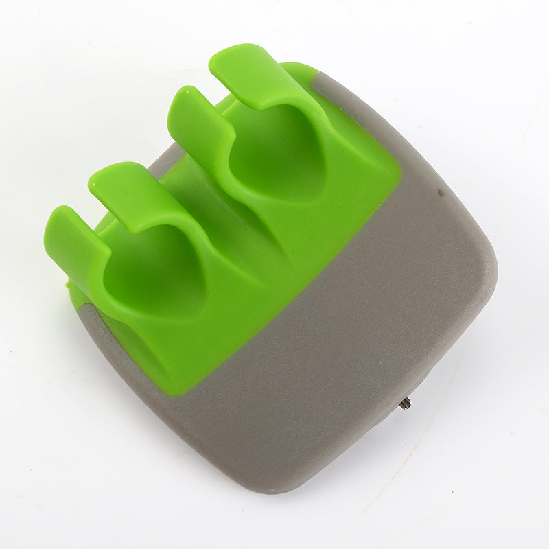 Green palm vegetable peeler on white background